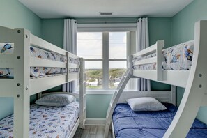 A bunk bed room with a window view, a ceiling vent, and a light switch. - 🌅Oceanfront  🏖️Steps to sand 🐶Dog Friendly⚡️EV charger (North Topsail Beach)