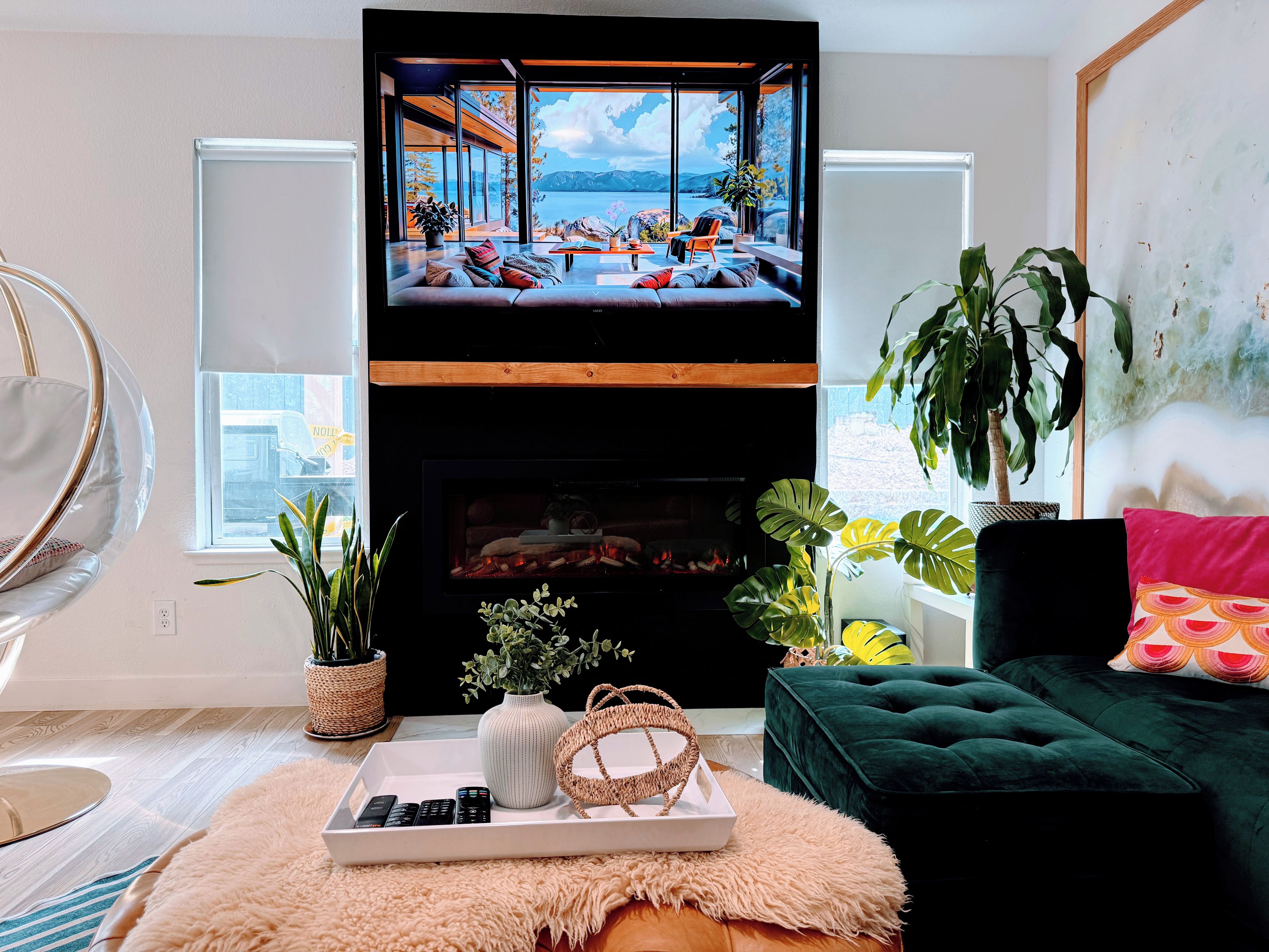 A living room with a television, sofa, and fireplace.