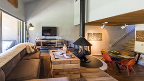 A modern living room with a sofa, coffee table, and a dining area with chairs. - Rustic Modern Retreat! 3bed/2bath Close to Lifts (Crested Butte)