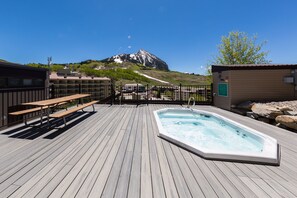 Relax on the deck with a hot tub and mountain views.