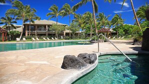 A swimming pool with lounge chairs and palm trees. - Best of Mauna Lani! Clean, Spacious Resort Townhome, Pool/Beach Club!  (KAMUELA)