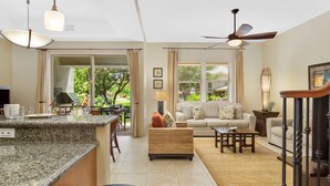 A spacious living area with a kitchen island, a sofa set, and a dining table. - Best of Mauna Lani! Clean, Spacious Resort Townhome, Pool/Beach Club!  (KAMUELA)