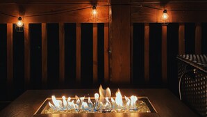 A fire feature with a wooden deck and string lights. - Beautiful cabin close to downtown Boone (Boone)