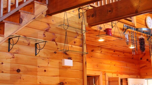 A wooden interior with a staircase, wooden beams, and a hanging light fixture. - Beautiful cabin close to downtown Boone (Boone)