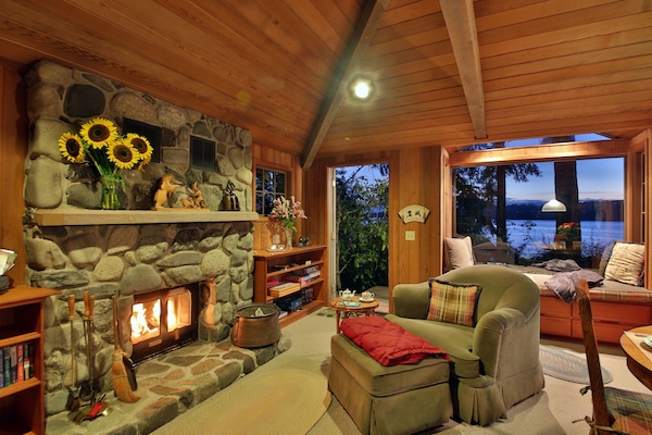 Cozy interior, wood fireplace, spectacular water views and picture window seat