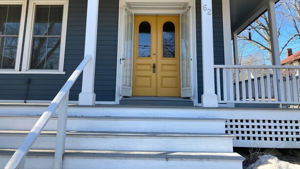 A house with a yellow front door, white columns, and a porch with a white railing. - Historic 1870’s Spacious Home-2 Blocks From Belfast Village and the Bay (Belfast)