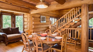 A log cabin interior with a dining area, a staircase, and a sofa. - Custom Log Cabin w/ MTN Views, 10 min. to fishing! (Basalt)