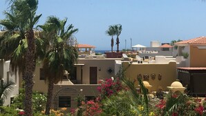 A residential area with palm trees, colorful flowers, and Mediterranean-style buildings with red-tiled roofs. - Charming Casa by the picturesque Sea of Cortes (Loreto)