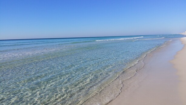 A beach with clear shallow waters and a sandy shore. - Paradise On The Beach With Crystal Clear Water & Gulf Front Complex--2 BR Suites (Navarre)