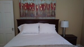 A neatly made bed with white linens, a wooden headboard, and a bedside table with a lamp. - CHARMING-Historic,Trinity University,Pearl Brewery, ONLY 3 miles to DT&Riverwalk (San Antonio)