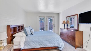 A bedroom with a wooden bed, a dresser, a mirror, and a TV. - Large Townhouse, 3Bd/3Ba, Near BYU Stadium/BYU  (Provo)