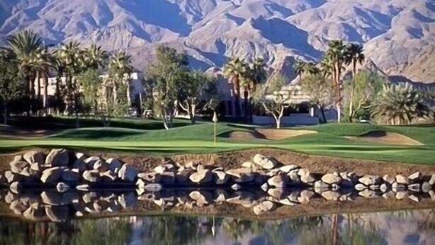 A golf course with a mountain backdrop, a pond reflecting the scenery, and palm trees. - PGA West La Quinta STR #068246 - Close to Golf, Tennis & Music Festivals (La Quinta)