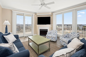 Beautiful living room with lots of natural light and views of the bay!