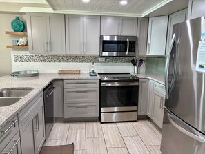 Enjoy cooking in this well-equipped kitchen with an oven, stovetop, and ample granite countertop space.