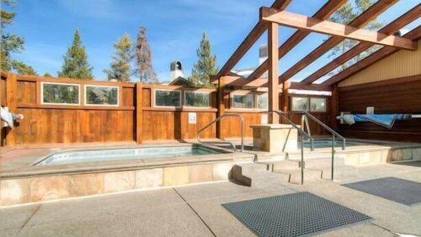 A wooden cabin with a pool, outdoor seating, and a covered area. - Best Location in Town! Ski-in/Ski-out on Peak 9! (Breckenridge)