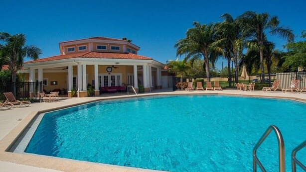 A swimming pool with a covered area, palm trees, and lounge chairs. - Beautiful pool great location near to the beach. Special Prices for Nov and Dec! (Sarasota)