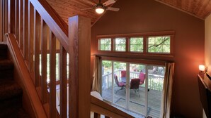 A wooden staircase leading to a deck with a ceiling fan, large windows, and outdoor furniture. - The Ashland Cottage, walk to town (Ashland)