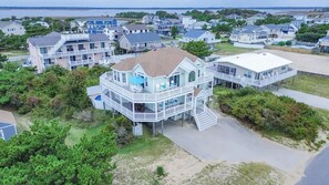 A coastal residential area with multiple two-story houses featuring balconies and waterfront views.