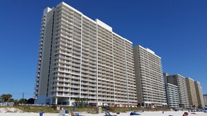 A high-rise hotel with multiple balconies and a beach view. - GREAT VIEW, FRIENDLY PRICES! (Panama City Beach)