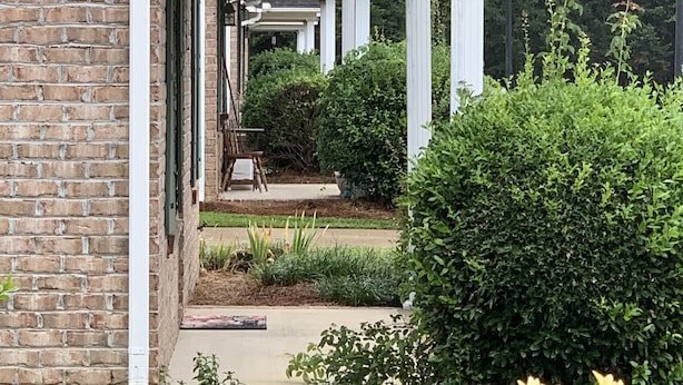 A building with a brick facade and a covered porch area.