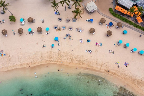 Colorful umbrellas dot the shoreline for bright, carefree beach days.