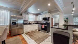 A modern kitchen with white cabinets, stainless steel appliances, and a central island. -  The Beverly Hills of Nashville, Close to it all! No stairs and a pool table  (Nashville)
