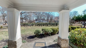 Welcome to a serene home surrounded by lush greenery and beautifully manicured lawns.