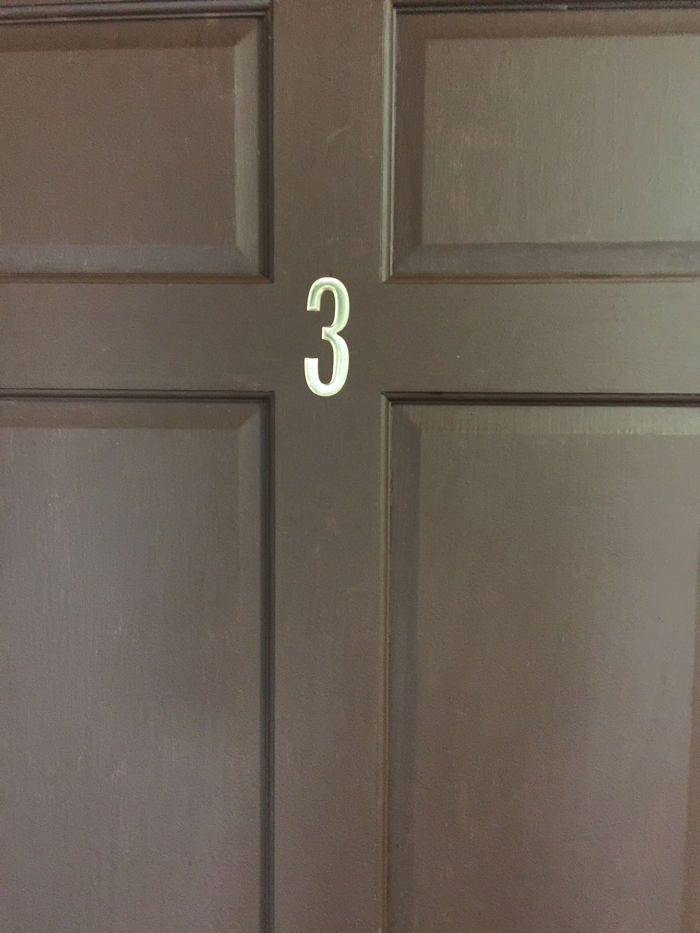 A door with a number "3" indicating a room number.