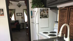 A kitchen with a sink, stove, refrigerator, and a calendar on the wall. - 2 bedroom, 1 bath apartment . Walk to Mayo, trails, parks, shopping, restaurants (Rochester)