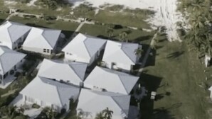 A coastal resort with multiple white-roofed buildings, palm trees, and a beach. - Luxury Vacation! The Best of the Best! Ocean Villa Treasure Cay, Bahamas (Treasure Cay)