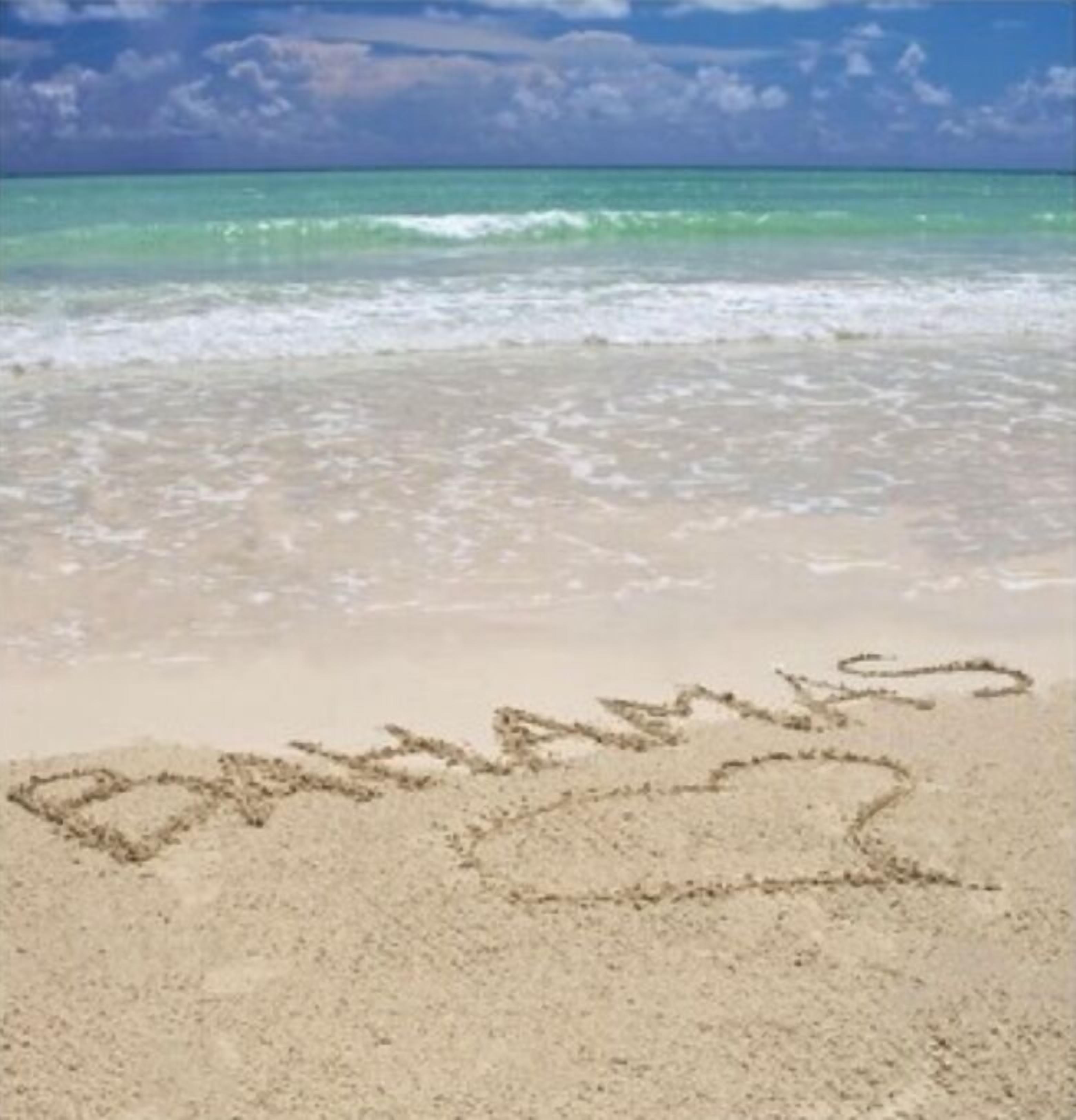 A beach with the word "Bahamas" written in the sand.