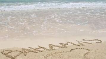 A beach with the word "Bahamas" written in the sand.