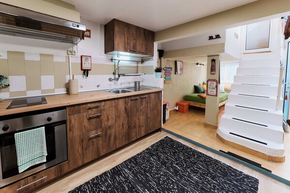 A kitchen with wooden cabinets, a stainless steel oven, and a tiled backsplash.