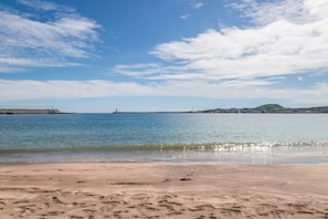 A beach with clear skies and calm waters.