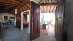 A room with a bed, a desk, and a dining area with chairs and a table. - Domus Anghelos ... in the Roman countryside (Roma)