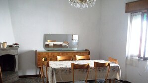 A dining room with a table set for four, a mirror on the wall, and a patterned floor. - sweet home sabina    (Montopoli di Sabina)