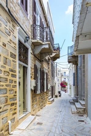 street outside the house where you sit on the marble steps in the evening