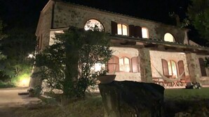 A stone building with arched windows and a central courtyard. -  Authentic Massa Marittima Get Away 220 sqm in the Tuscan countryside  (Massa Marittima)