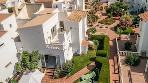 A residential area with white buildings, red-tiled roofs, and well-maintained gardens. - Two Bedroomed Villa With Private Pool. (Torrevieja)