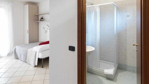 A bedroom with a bed, a bedside table, and a wardrobe. There is a bathroom with a shower, a sink, and tiled walls. - Residence -2 Saint Benedict of Lugana (Peschiera Del Garda)