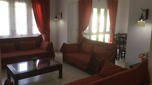 A living room with two sofas, a coffee table, and a dining area with chairs. - Extremely private villa with own pool (heating optional) - sleeps up to 6 (El Gouna)