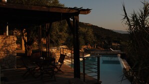 A poolside area with a pergola, stone walls, and outdoor furniture. - Melolia A2 holiday home with pool and fabulous views (Alyki)