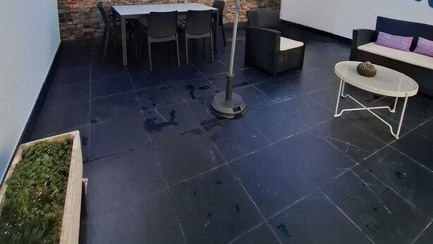A rooftop patio with a table and chairs, a large umbrella, a sofa, and a small potted plant. - RENDEZ VOUS PORTO I (T1) (Paranhos - Porto)