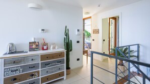 A modern interior with a wooden dresser, a cactus, and a staircase. - Relaxing Oasis: Villa with Private Pool & View (Baveno)