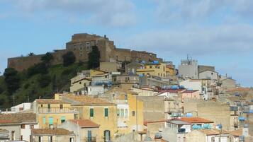 A historic hilltop town with a prominent castle-like structure.