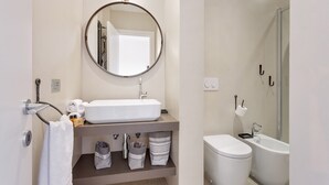 A modern bathroom with a round mirror, white sink, and a glass-enclosed shower. - Studio Vaticano Int. 5B - Terrace with View on San Pietro (Roma)