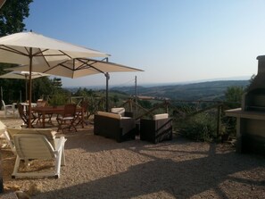 Enjoy al fresco dining with a barbecue grill and scenic views of rolling hills and distant mountains.
