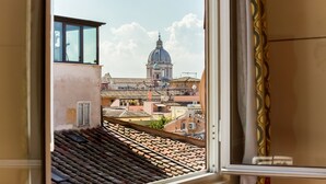 A view from a window overlooking a cityscape with a prominent dome building in the distance.