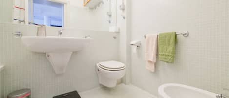 A bathroom with a sink, toilet, and bathtub.