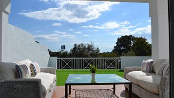 Relax on the patio surrounded by lush greenery and enjoy the clear view.